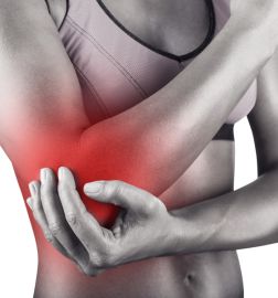 Woman with pain in the elbow isolated on white background. Front view